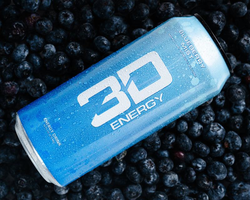 Blue energy drink can on a bed of blueberries